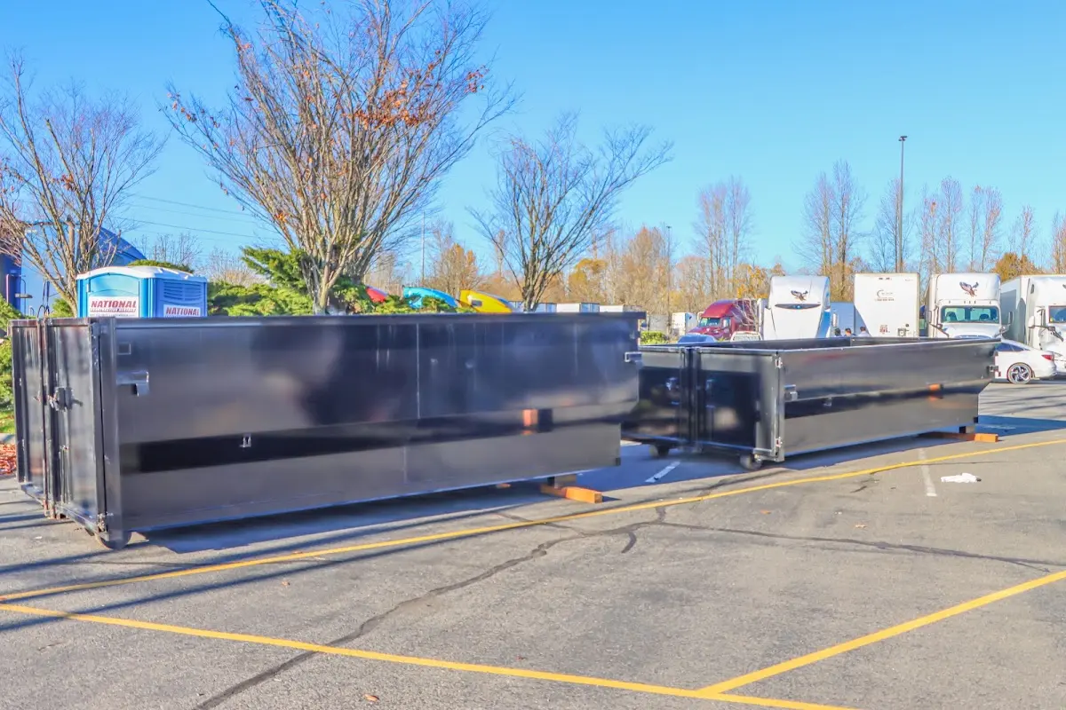 Professional dumpster rental service with roll-off container on residential driveway in Albion